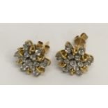 A pair of 18ct white and yellow gold diamond star