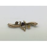 A 9ct gold brooch set with a central amethyst and