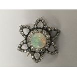 A fine Antique brooch set with central opal surrou