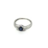 A 10k White gold ring set with a sapphire and chip