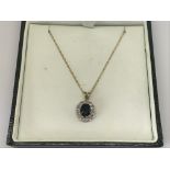 A 9ct gold necklace with diamond and sapphire pend