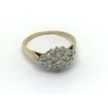 A 9carat gold ring set with a pattern of brilliant