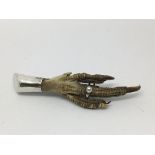 A hallmarked silver mounted birds claw. With marks