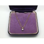 A diamond pendant on a 9ct gold chain, approx 1/4c