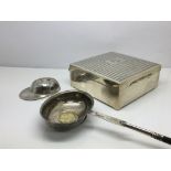 A silver cigarette box, toddy ladle inset with a G