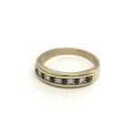 A 9carat gold ring set with an alternating row of