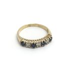 An 18carat gold ring set with an alternating patte