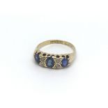 A circa 1920s 18ct gold ring set with three sapphi