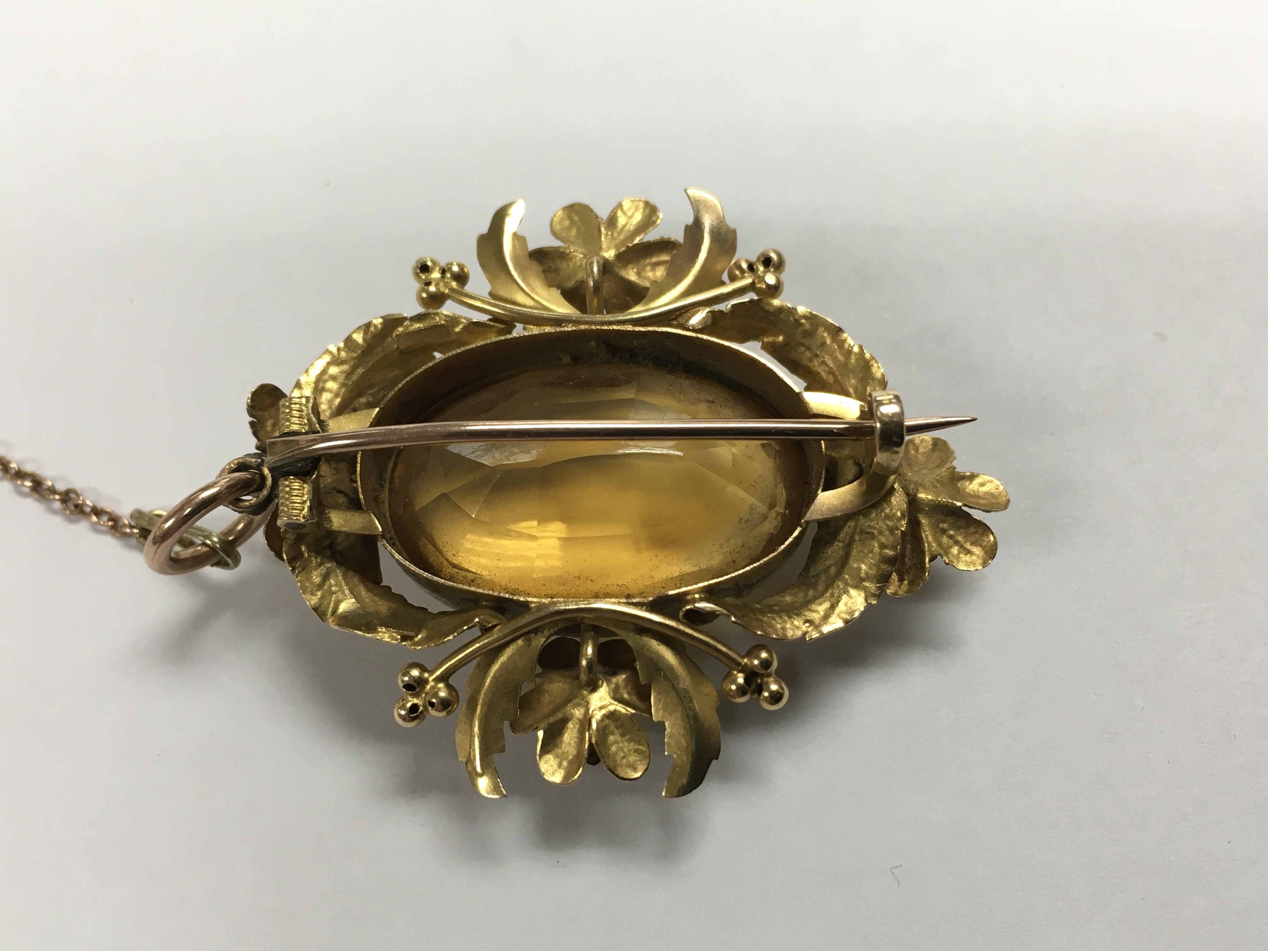 A unmarked Victorian brooch set with large cut citrine surrounded by a fancy foliate mount, 4 cm. - Image 2 of 2