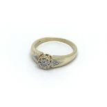 A 9carat gold ring set with a central floral patte