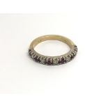 An 18 carat gold ring set with alternating RubyÕs