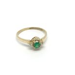 An 18carat Gold Emerald and diamond ring size K.