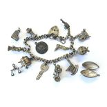 A silver charm bracelet with a number of charms, a