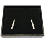 A pair of 9K marked white gold half hoop earrings,