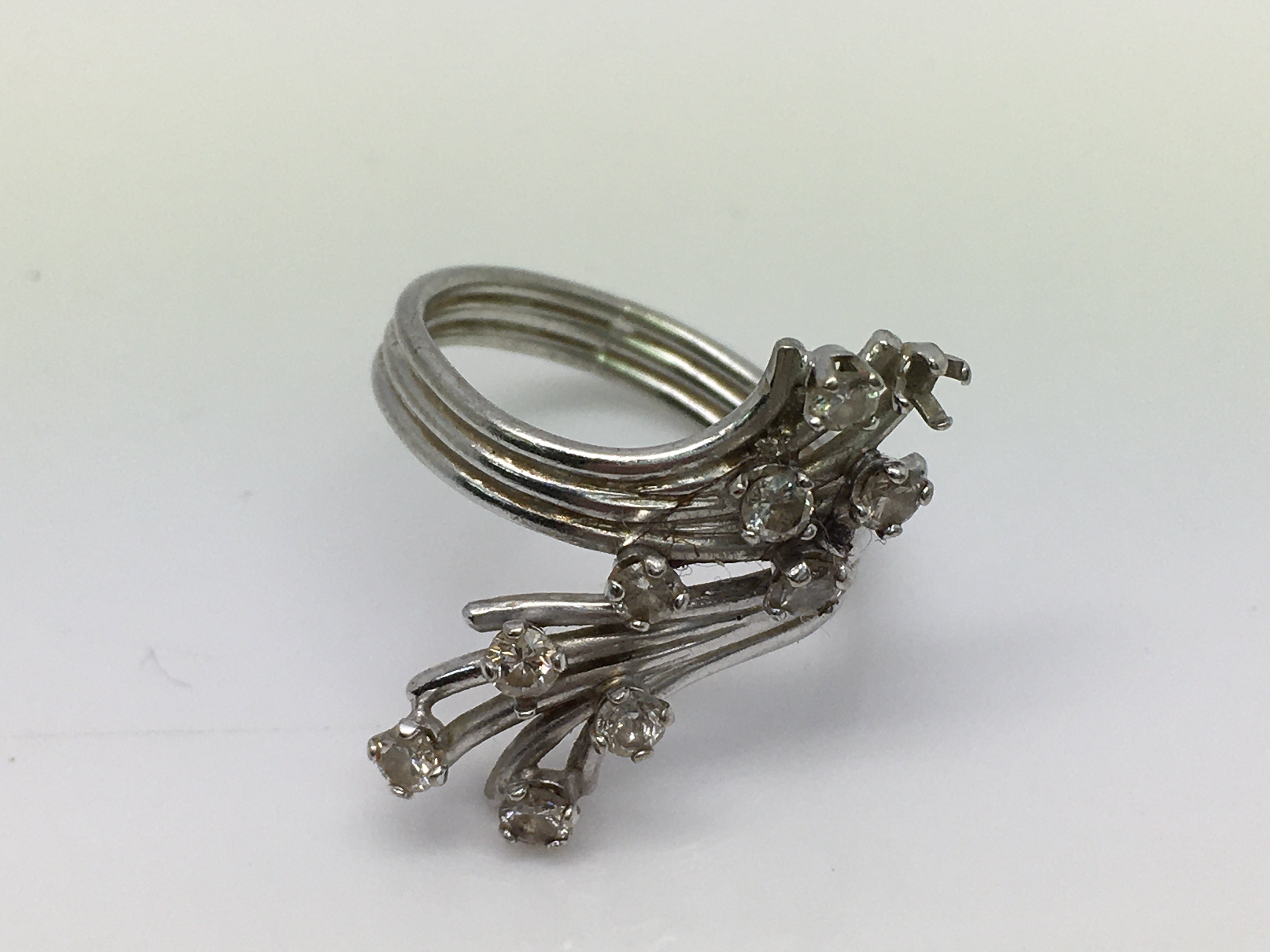 A white metal and diamond set ring ( 1stone missin