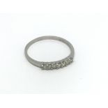 An 18ct white gold seven stone diamond ring, appro