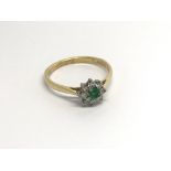 An 18carat gold ring set with a green emerald and