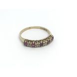 A 9ct almondine garnet and diamond ring, (P), 1.3g