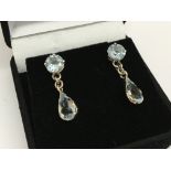 A pair of 14ct white gold drop earrings set with a