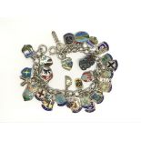 A silver and enamel charm bracelet including tiki