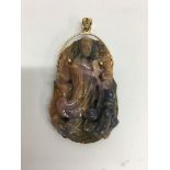 A multicoloured carved sapphire pendant in the for