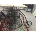 Old Iron child's Penny Farthing bicycle with solid tyres and wood and leather saddle