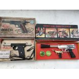 A collection of boxed toy guns including Colt Mach