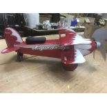 Child's red and white ride-on biplane with wheel driven propellor