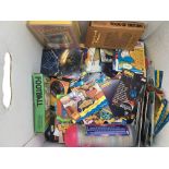 A box containing trading cards, tazos, pogs etc