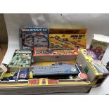 A box containing boxed toys including Matchbox motor city, Minicity play set, a basketball game, and