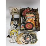 A collection of vintage beer mats and match boxes.