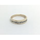 A 9carat gold ring half hoop eternity ring set with a row of brilliant cut diamonds ring size O.