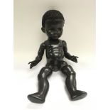 A black Pedigree doll.