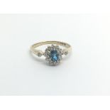 A 9carat gold ring set with a blue topaz and flank
