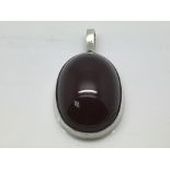 A silver and cherry amber pendant, approx 41mm x 2