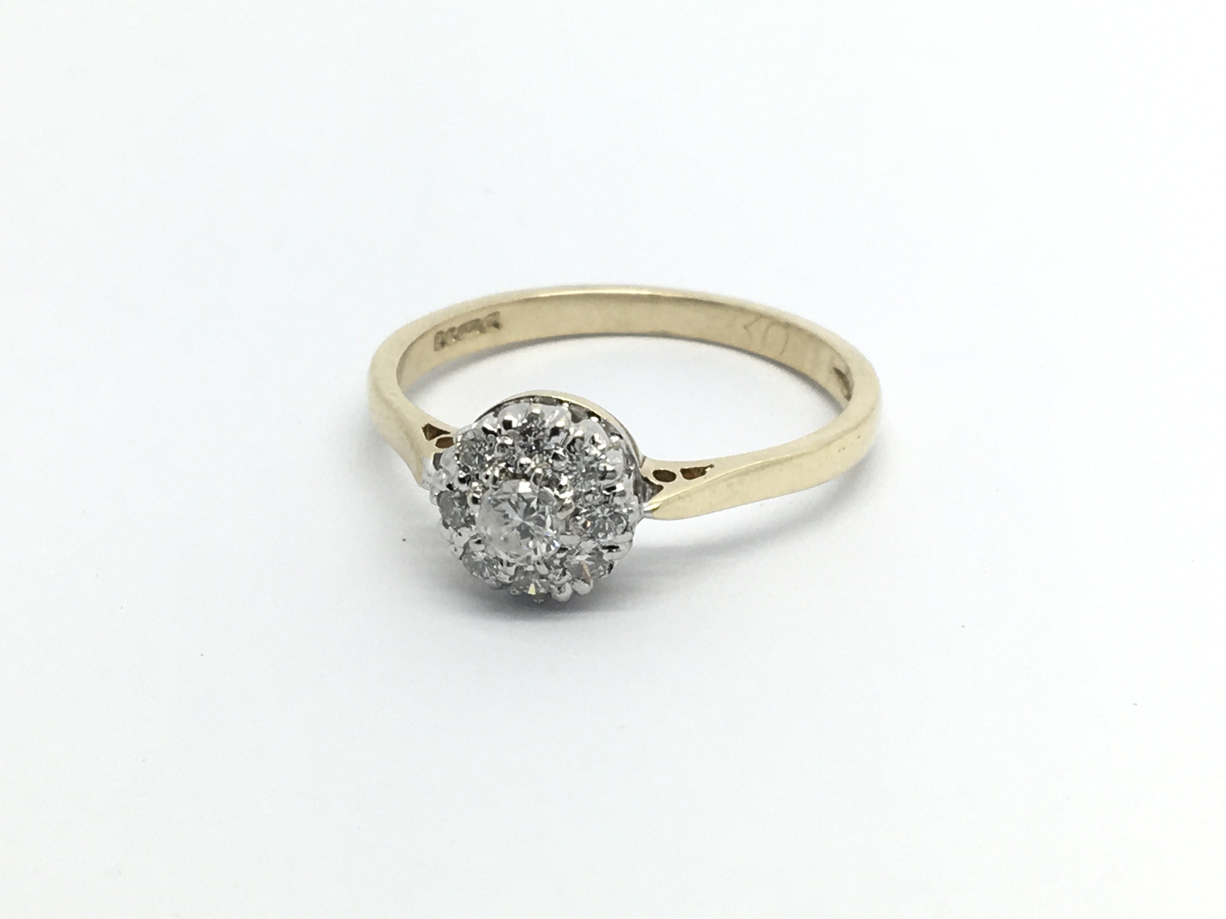 A 9carat gold ring set with a cluster of diamonds ring size O.