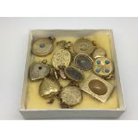 A collection of gold tone lockets comprising heart shaped examples, a mourning locket etc.