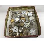 A tin of watch movements.