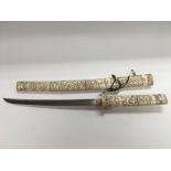 A 19th Century Japanese short sword with carved bo