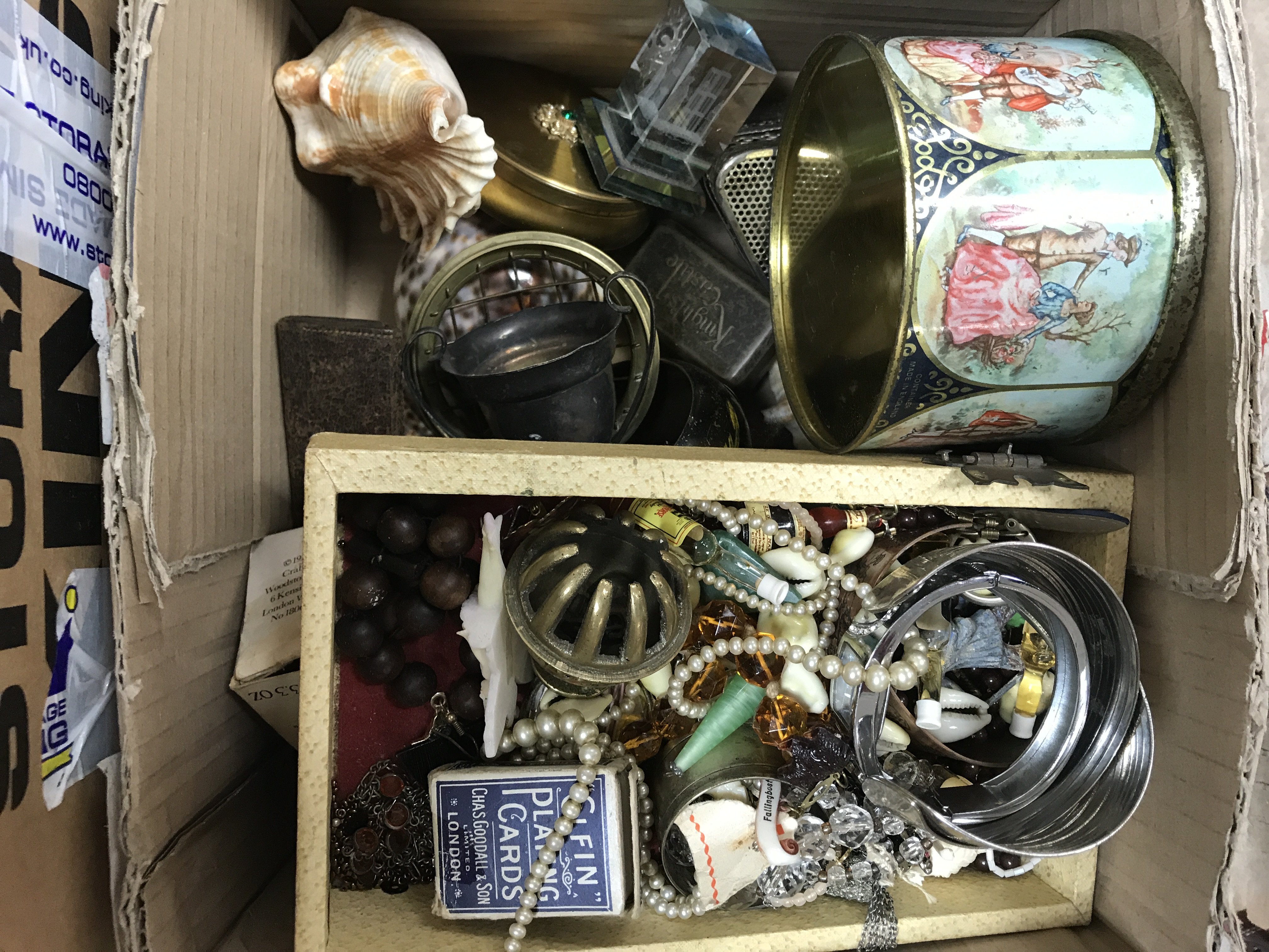 A box of mixed costume jewellery and various oddments.
