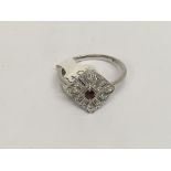 A 18 ct white gold ring of Art Deco form inset wit