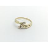 An 18carat gold two stone diamond crossover ring size K.