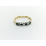 An 18carat gold ring set with emerald and alternat