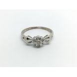 A 9carat white gold ring set with a pattern of dia