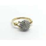 An 18carat gold ring set with a cluster of diamond