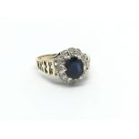 A 9carat gold deep blue sapphire and diamond ring