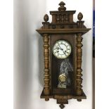 A Victorian Vienna wall clock with key and pendulu