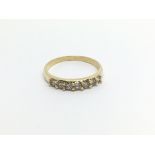 An 18carat gold ring set with a row of diamonds. r
