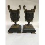 A pair of French bronze parcel gilt vases of Class