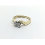 An 18carat gold ring two stone diamond crossover Approximately 0.33 of a carat ring size L-M